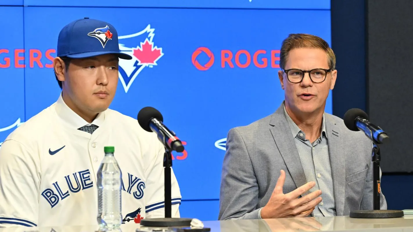 Toronto Blue Jays general manager Ross Atkins speaks to the media with Kazuma Okamoto during the press conference room at Rogers Centre.