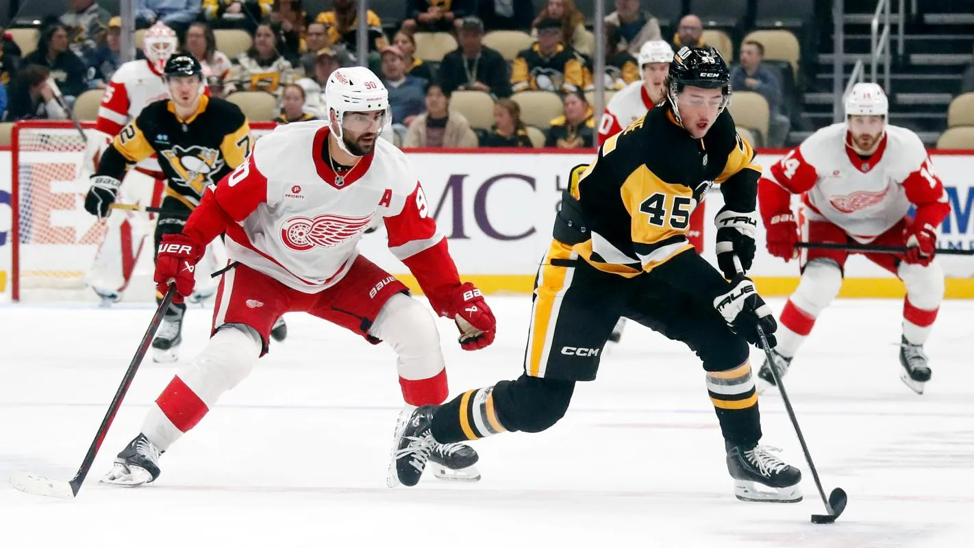 Pittsburgh Penguins defenseman Harrison Brunicke (45) handles the puck ahead of Detroit Red Wings center Joe Veleno (90) during the second period at PPG Paints Arena.