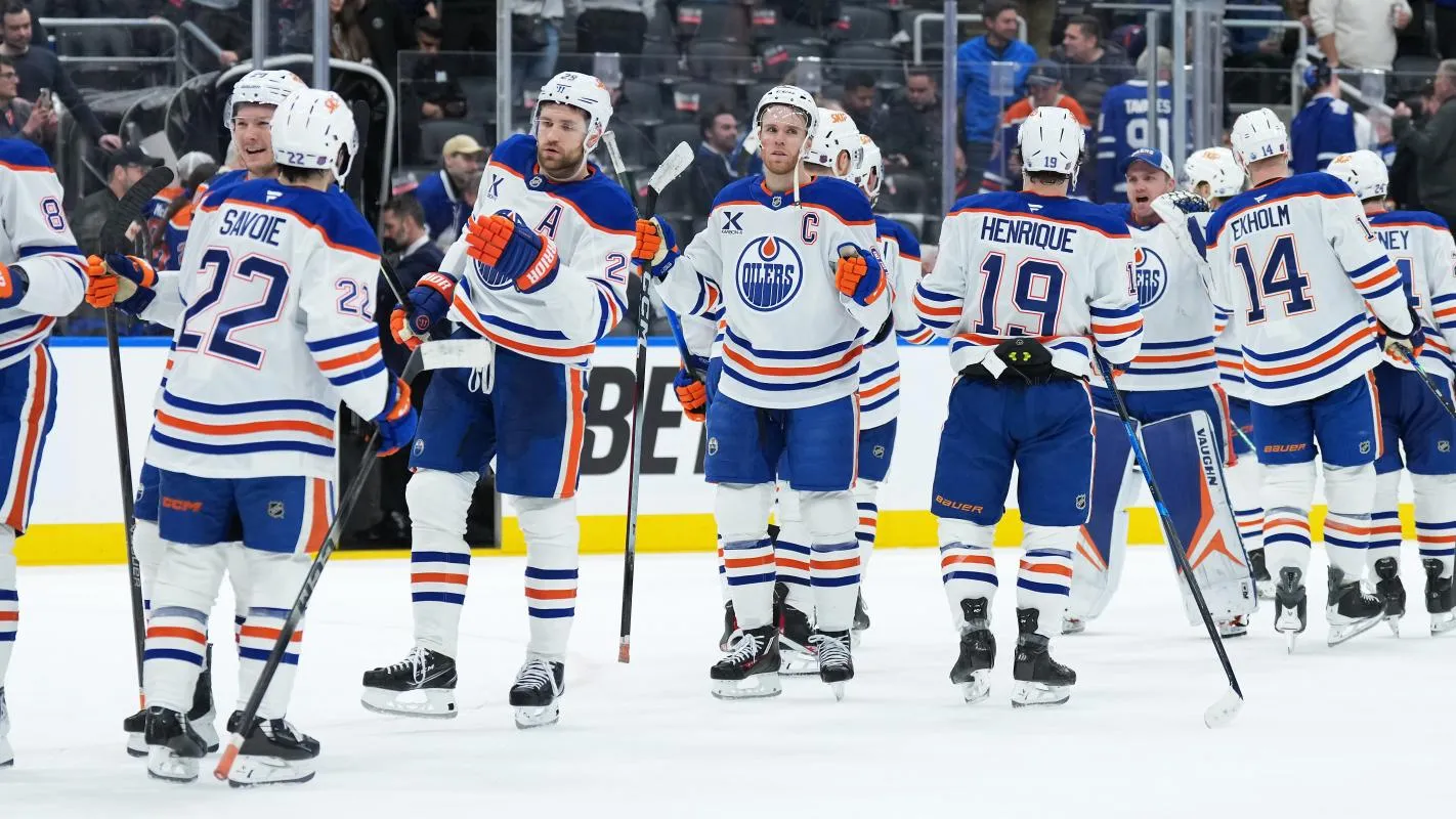 Edmonton Oilers center Connor McDavid (97) celebrates the win with center Adam Henrique (19) against the Toronto Maple Leafs at the end of the third period at Scotiabank Arena.