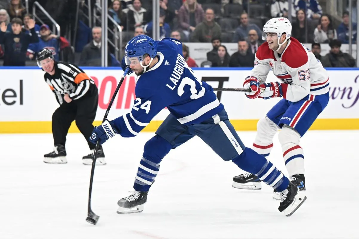 Toronto Maple Leafs forward Scott Laughton (24) hits a slapshot that scores a goal as Montreal Canadiens defenseman Noah Dobson (53) trails the play in the third period at Scotiabank Arena.