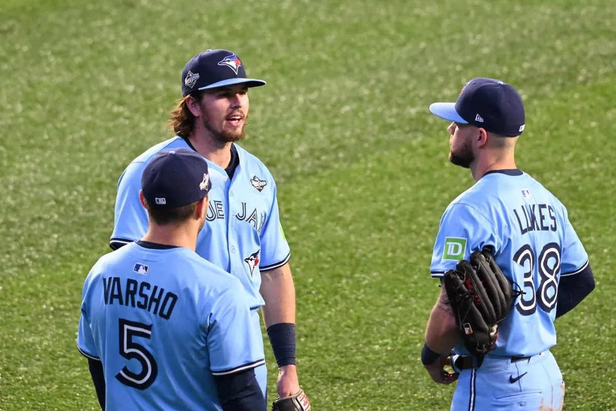 Toronto Blue Jays center fielder Daulton Varsho (5) and third baseman Addison Barger (47) and right fielder Nathan Lukes (38) talk in the outfield in the eighth inning against the Los Angeles Dodgers during game six of the 2025 MLB World Series at Rogers Centre.