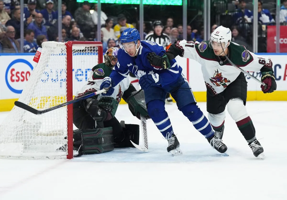 Toronto Maple Leafs left wing Michael Bunting (58) battles with Arizona Coyotes defenseman Dysin Mayo (61) during the first period at the Scotiabank Arena.