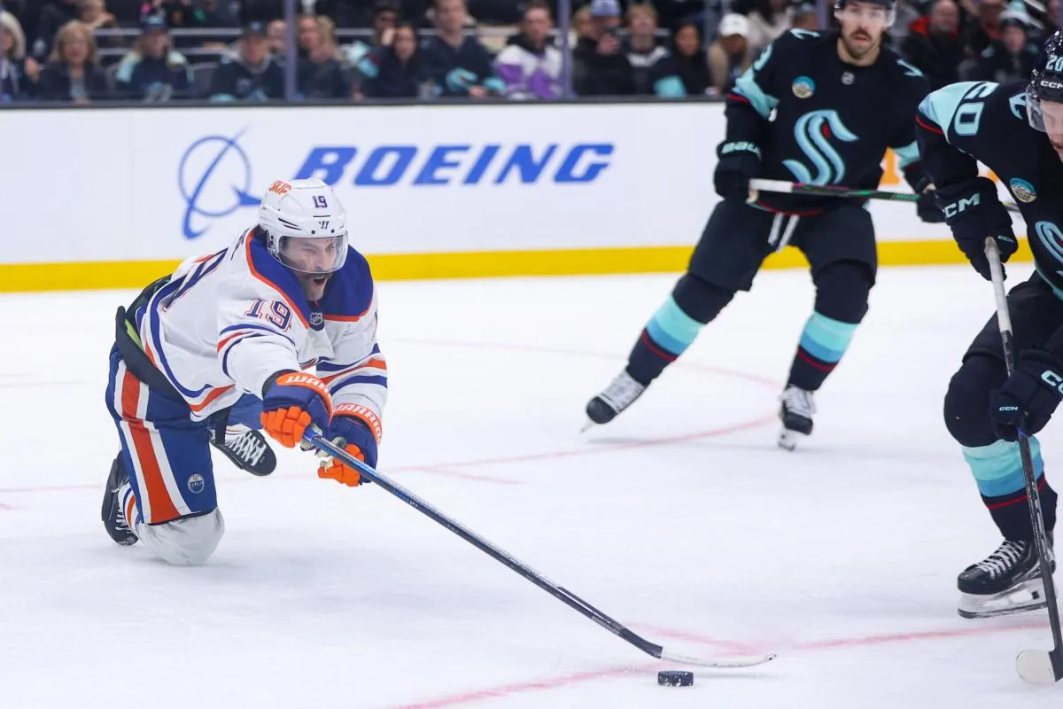 Edmonton Oilers center Adam Henrique (19) reaches for the puck in the second period against the Seattle Kraken at Climate Pledge Arena.