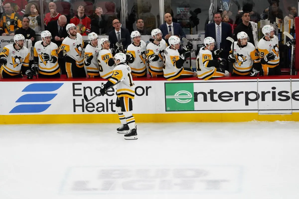 Pittsburgh Penguins right wing Bryan Rust (17) celebrates scoring a goal against the Chicago Blackhawks during the first period at United Center.