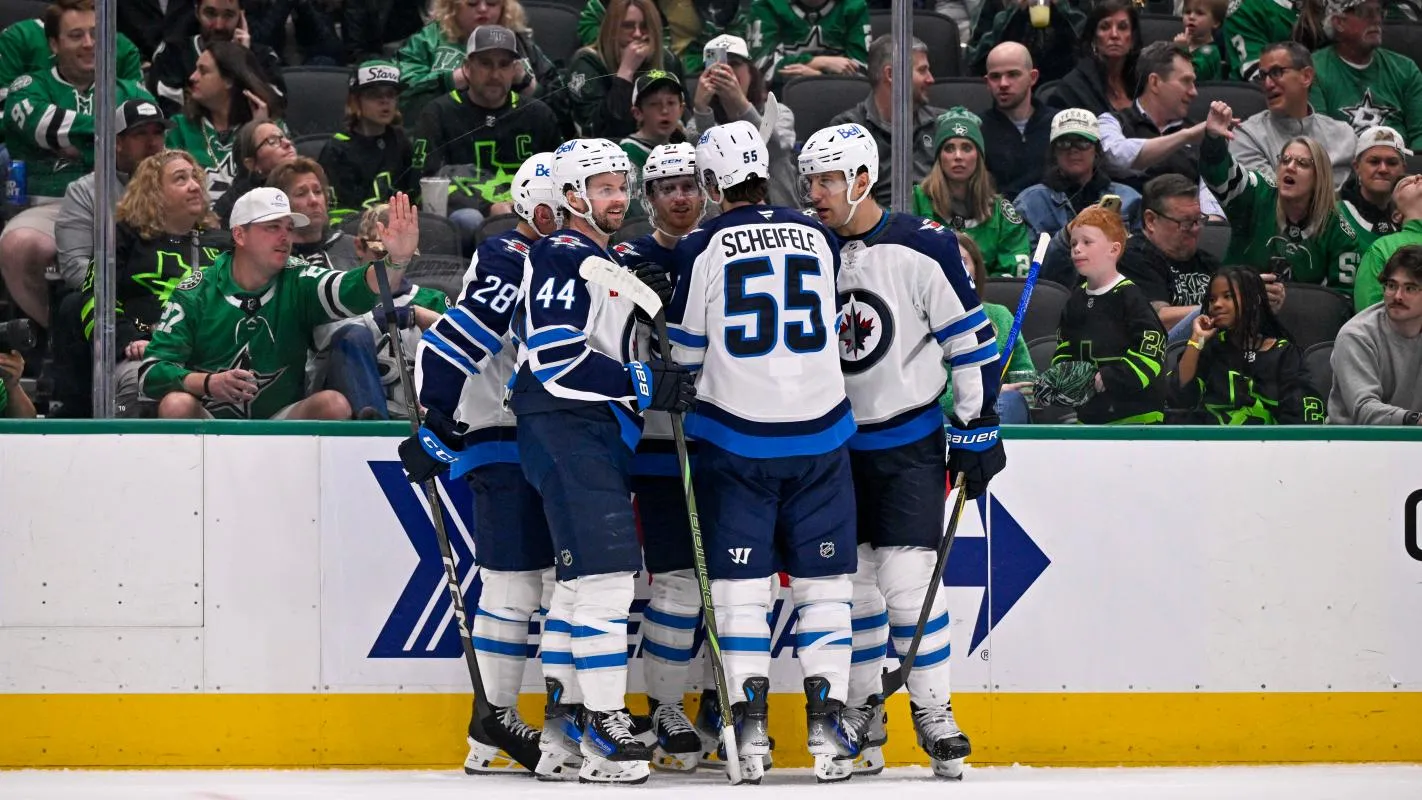 Winnipeg Jets center Jaret Anderson-Dolan (28) and defenseman Josh Morrissey (44) and center Mark Scheifele (55) and defenseman Luke Schenn (5) celebrates a goal scored by left wing Kyle Connor (81) against the Dallas Stars during the third period at the American Airlines Center.