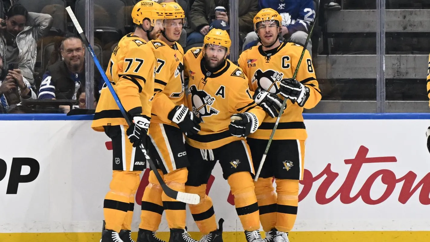 Pittsburgh Penguins forward Bryan Rust (17) celebrates with forwards Sidney Crosby (87) and Rickard Rakell (67) and defenseman Brett Kulak (77) after scoring a goal against the Toronto Maple Leafs in the first period at Scotiabank Arena.