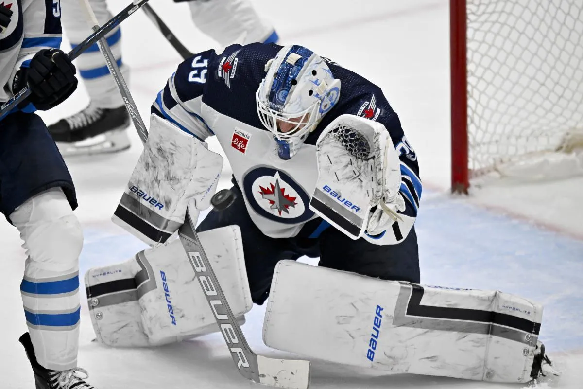 Winnipeg Jets goaltender Laurent Brossoit (39) makes a glove save on a Dallas Stars shot during the second period at the American Airlines Center