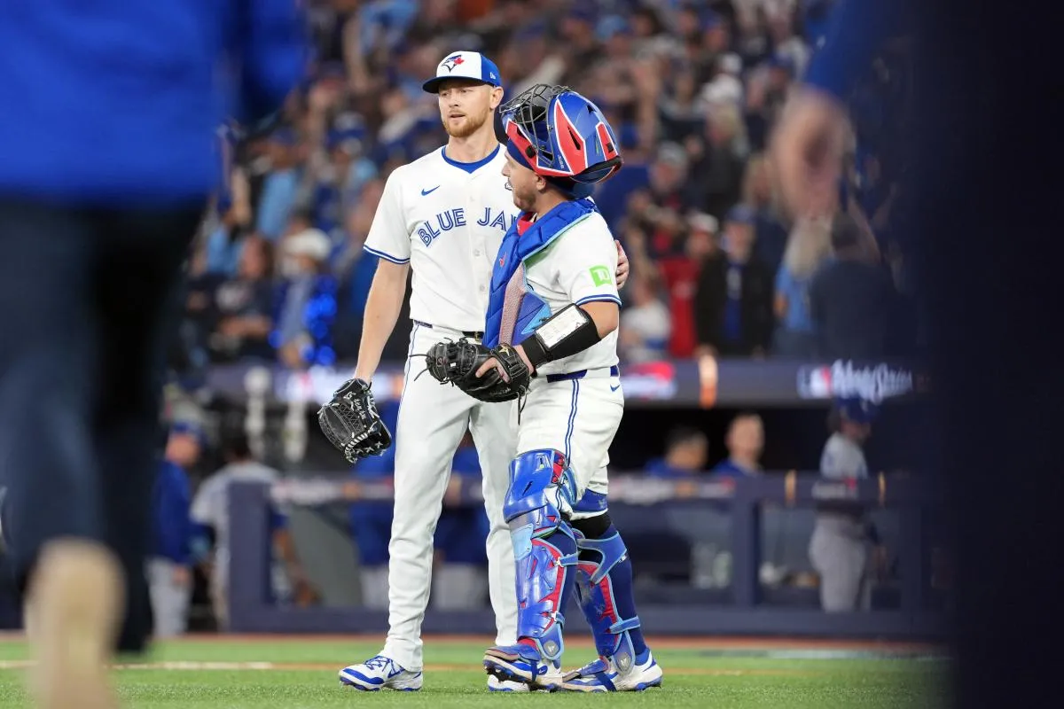 Toronto Blue Jays pitcher Eric Lauer (56) celebrates with catcher Alejandro Kirk (30) after defeating the Los Angeles Dodgers in game one of the 2025 MLB World Series at Rogers Centre