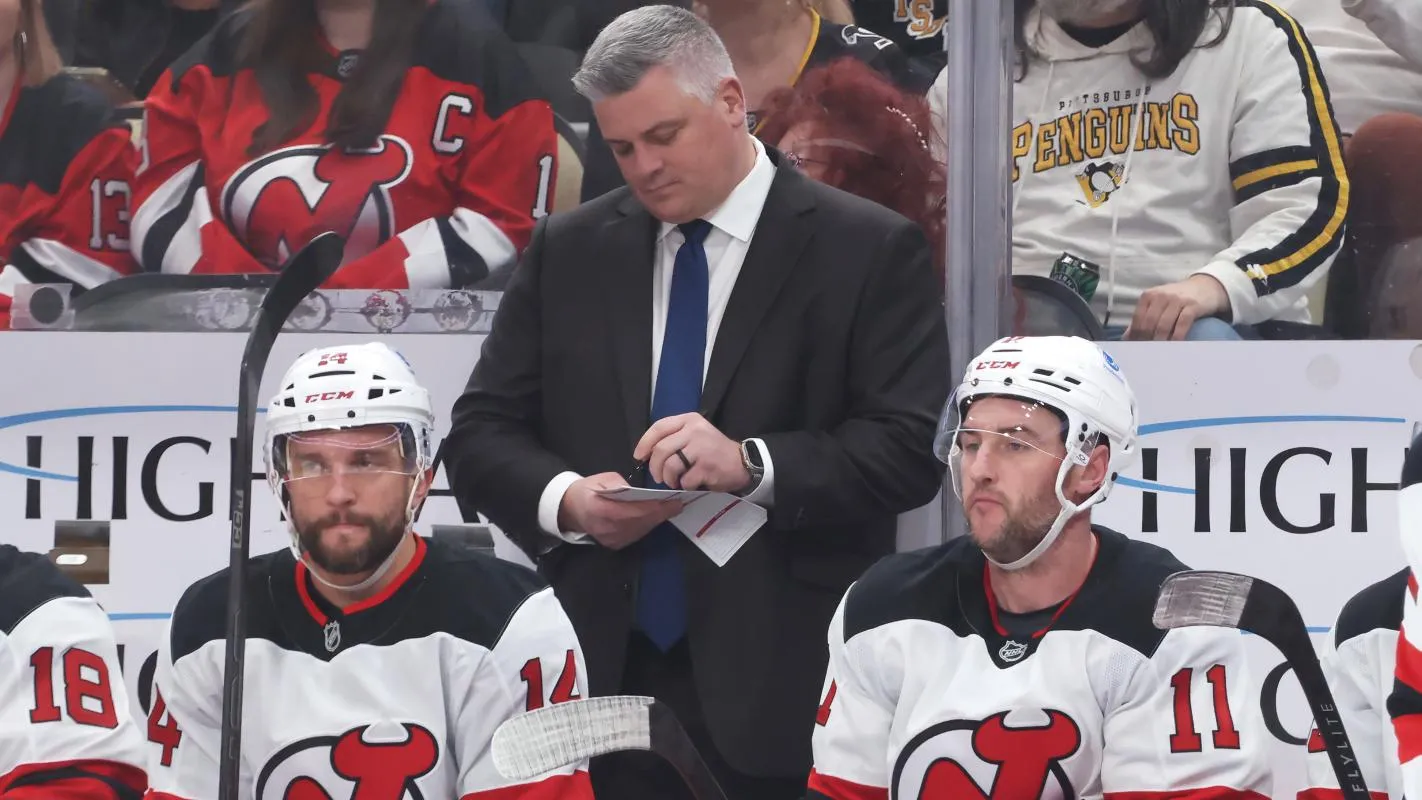 New Jersey Devils head coach Sheldon Keefe makes a note on the bench against the Pittsburgh Penguins during the first period at PPG Paints Arena.