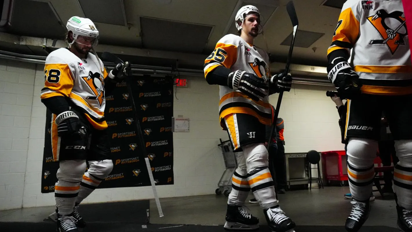 Pittsburgh Penguins defenseman Erik Karlsson (65) and defenseman Kris Letang (58) come out of the locker room before the start of the second period against the Carolina Hurricanes at PNC Arena.