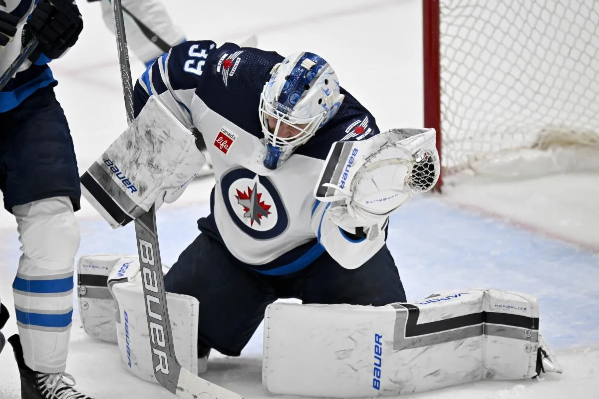 Winnipeg Jets goaltender Laurent Brossoit (39) makes a glove save on a Dallas Stars shot during the second period at the American Airlines Center.