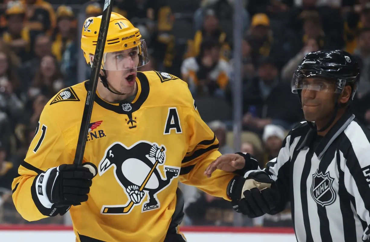 Pittsburgh Penguins center Evgeni Malkin (71) reacts to the Seattle Kraken as linesman Shandor Alphonso (52) restrains Malkin during the third period at PPG Paints Arena.