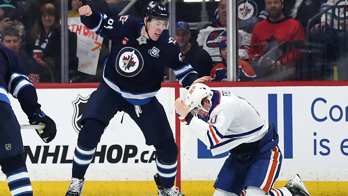 Winnipeg Jets defenseman Logan Stanley (64) fights with Edmonton Oilers center Trent Frederic (10) in the second period at Canada Life Centre.