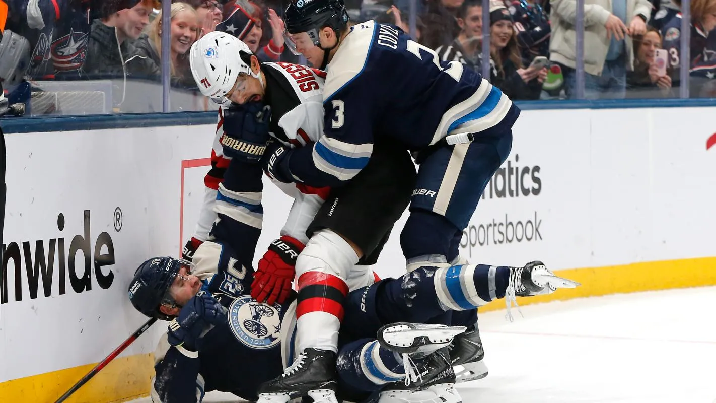 New Jersey Devils defenseman Jonas Siegenthaler (71) falls on top of Columbus Blue Jackets center Boone Jenner (38) as Charlie Coyle (3) pulls him away during the second period at Nationwide Arena.