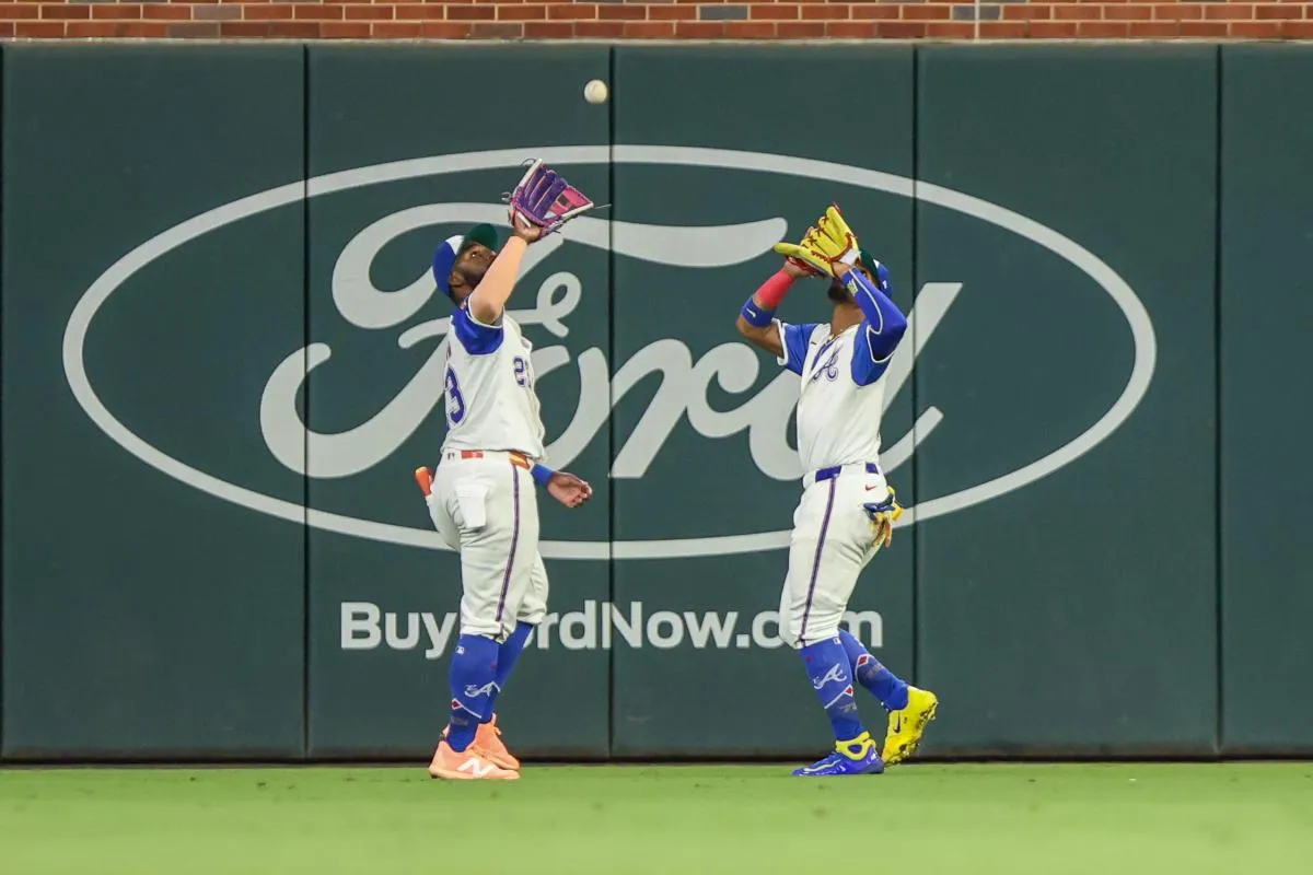 Atlanta Braves outfielder Michael Harris II (23) and outfielder Ronald Acuna Jr. (13) run to catch the fly ball for an out against the Pittsburgh Pirates during the eighth inning at Truist Park.