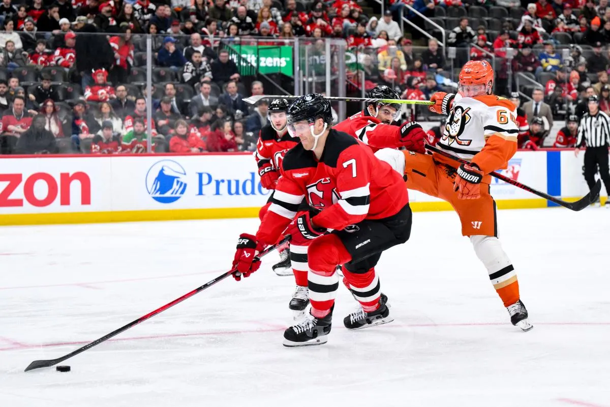 New Jersey Devils defenseman Dougie Hamilton (7) skates with the puck as defenseman Jonas Siegenthaler (71) checks Anaheim Ducks center Mikael Granlund (64) during the third period at Prudential Center.