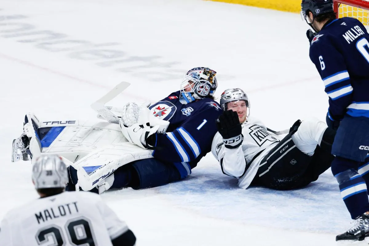 Los Angeles Kings forward Taylor Ward (52) collides with Winnipeg Jets goalie Eric Comrie (1) during the third period at Canada Life Centre.