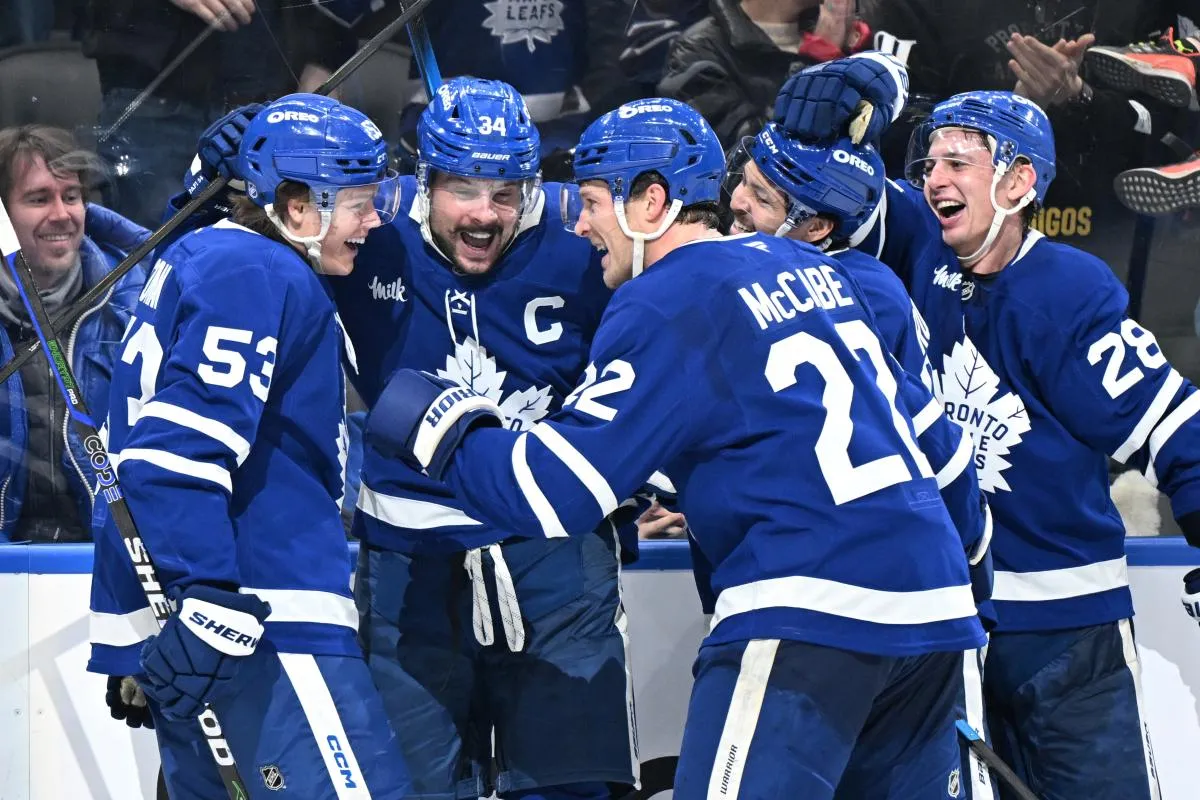 Toronto Maple Leafs forward Auston Matthews (34) celebrates with forwards Easton Cowan (53) and Nick Robertson (89) and defensemen Jake McCabe (22) and Troy Stecher (28) after scoring his third goal of the game against the Winnipeg Jets in the third period at Scotiabank Arena.