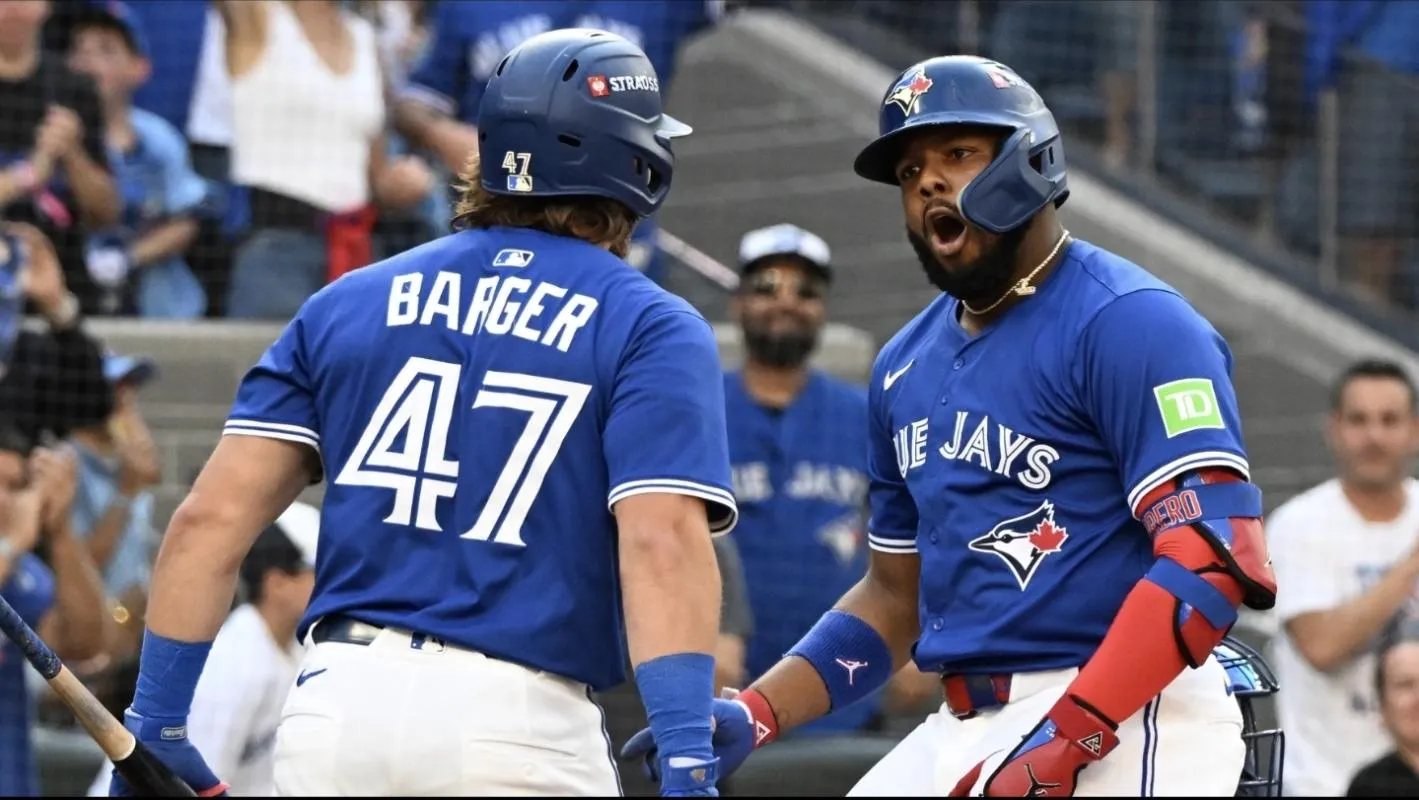 Toronto Blue Jays first baseman Vladimir Guerrero Jr. (27) celebrates with third baseman Addison Barger (47) after hitting a home run in the first inning against the New York Yankees during game one of the ALDS round for the 2025 MLB playoffs at Rogers Centre.