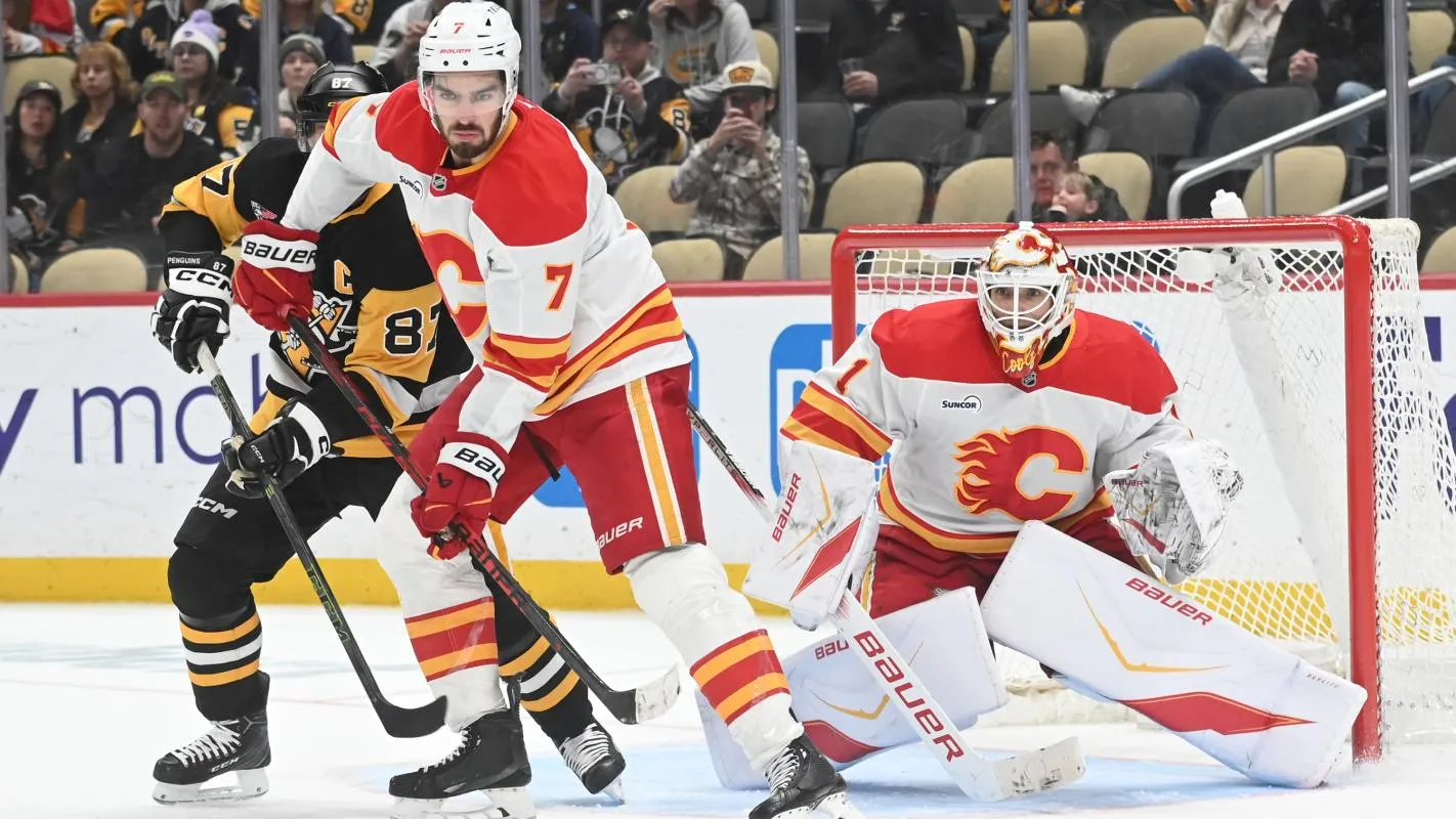 Calgary Flames defenseman Kevin Bahl (7) directs the puck from Pittsburgh Penguins center Sidney Crosby (87) near goalie Devin Cooley (1) during the third period at PPG Paints Arena.