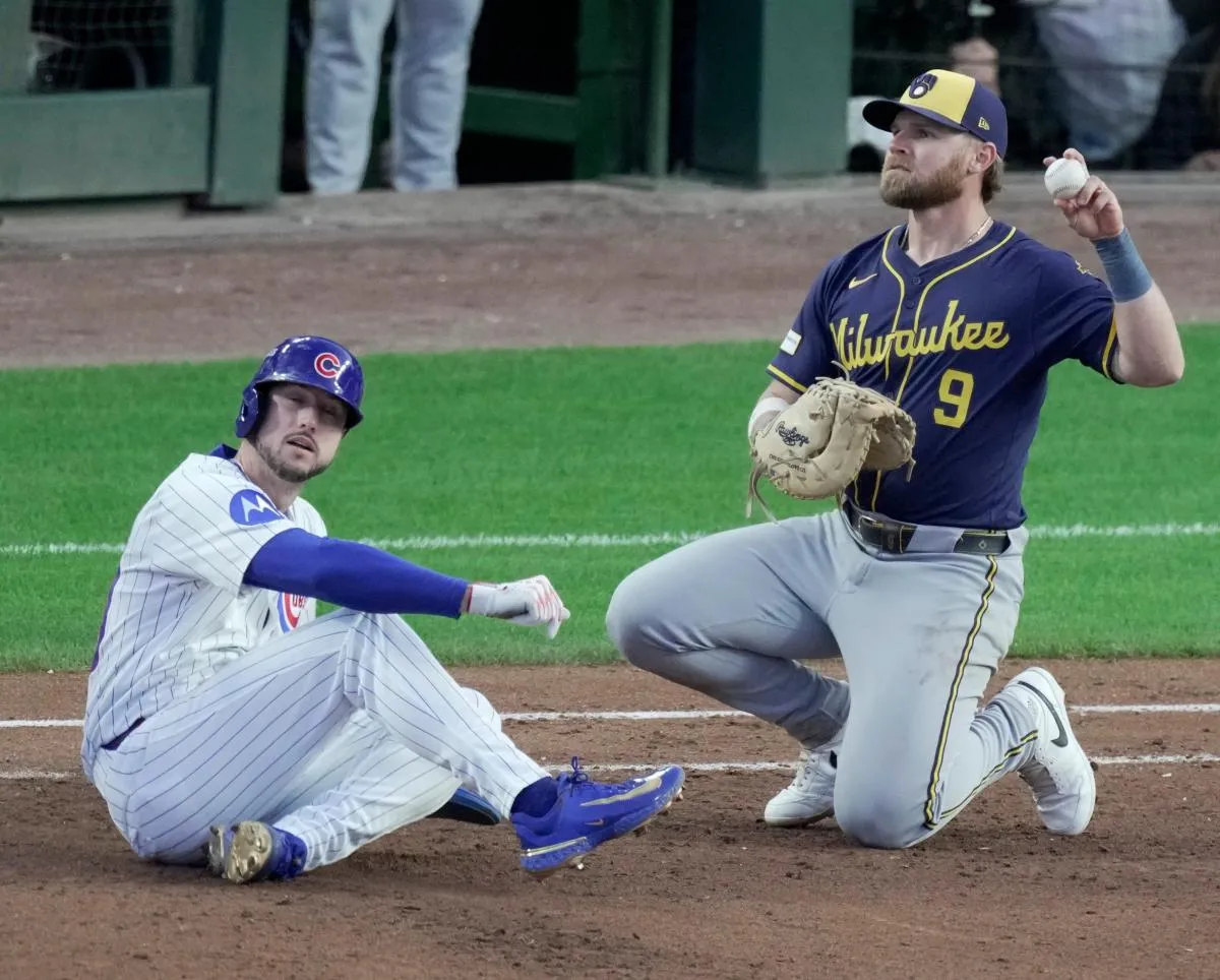 Chicago Cubs right fielder Kyle Tucker is tagged out by Milwaukee Brewers left fielder Jake Bauers (9) on a pick off during the fifth inning of their National League Division Series game Wednesday, October 8, 2025 at Wrigley Field in Chicago, Illinois.