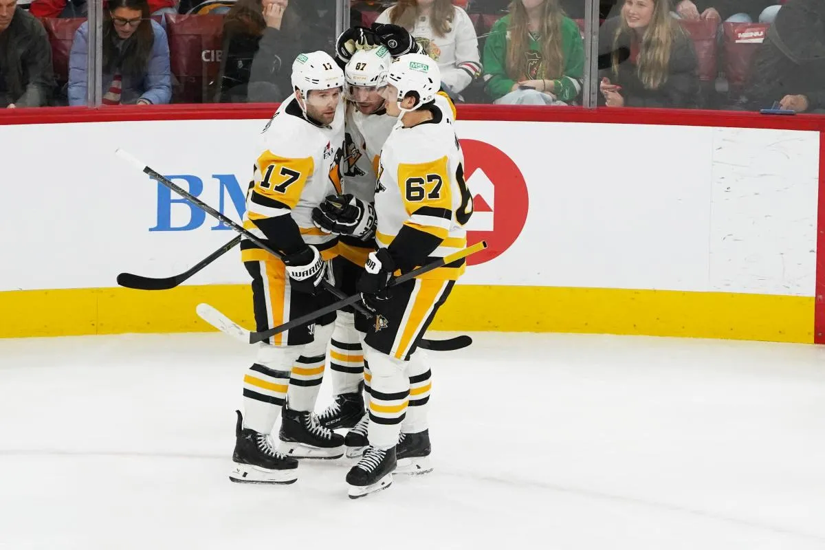 Pittsburgh Penguins right wing Bryan Rust (17) celebrates scoring a goal with center Sidney Crosby (87) and right wing Rickard Rakell (67) against the Chicago Blackhawks during the first period at United Center.