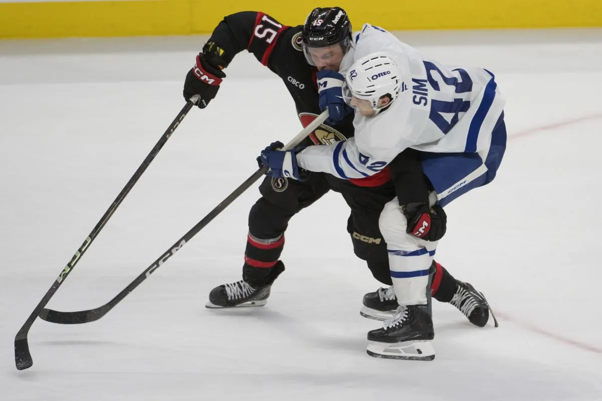 Ottawa Senators left wing Olle Lycksell (15) battles with Toronto Maple Leafs left wing Landon Sim (42) for control of the puck in the third period at the Canadian Tire Centre