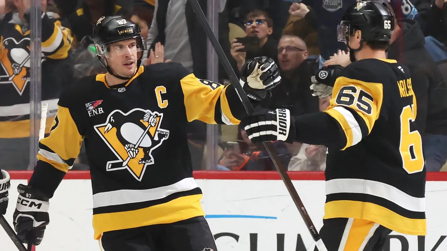Pittsburgh Penguins center Sidney Crosby (87) congratulates defenseman Erik Karlsson (65) on his goal against the Edmonton Oilers during the second period at PPG Paints Arena.