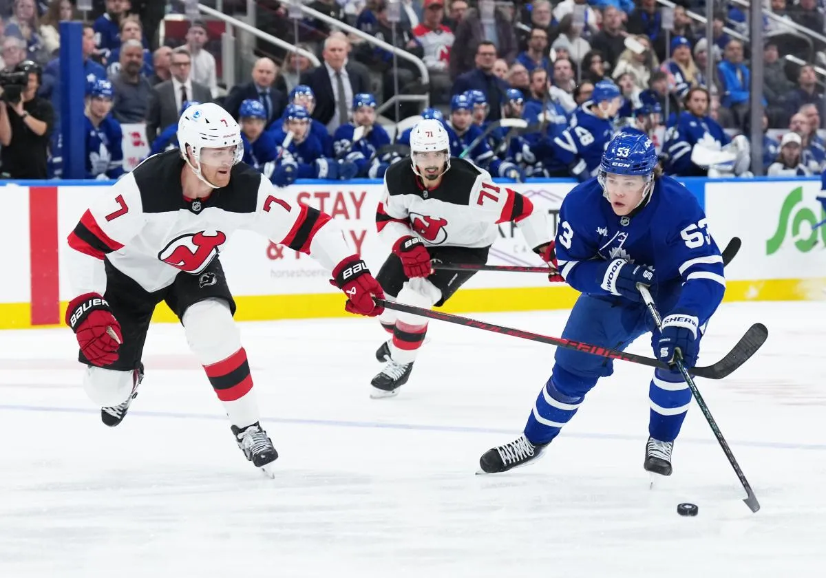 Toronto Maple Leafs right wing Easton Cowan (53) skates with the puck as New Jersey Devils defenseman Dougie Hamilton (7) gives chase during the third period at Scotiabank Arena.