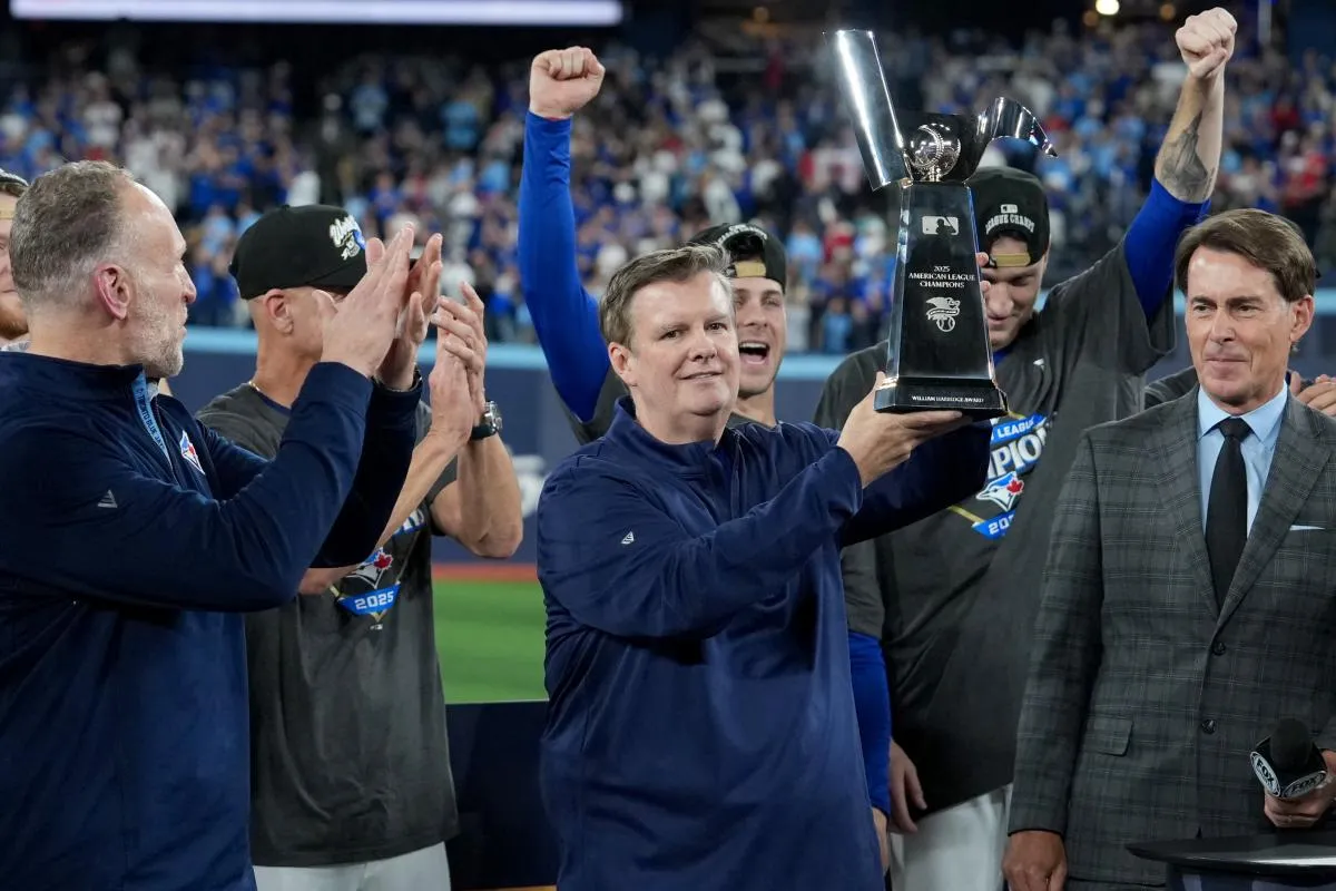 Toronto Blue Jays owner Edward Rogers celebrates with the trophy after the win against the Seattle Mariners in game seven of the ALCS round for the 2025 MLB playoffs at Rogers Centre.