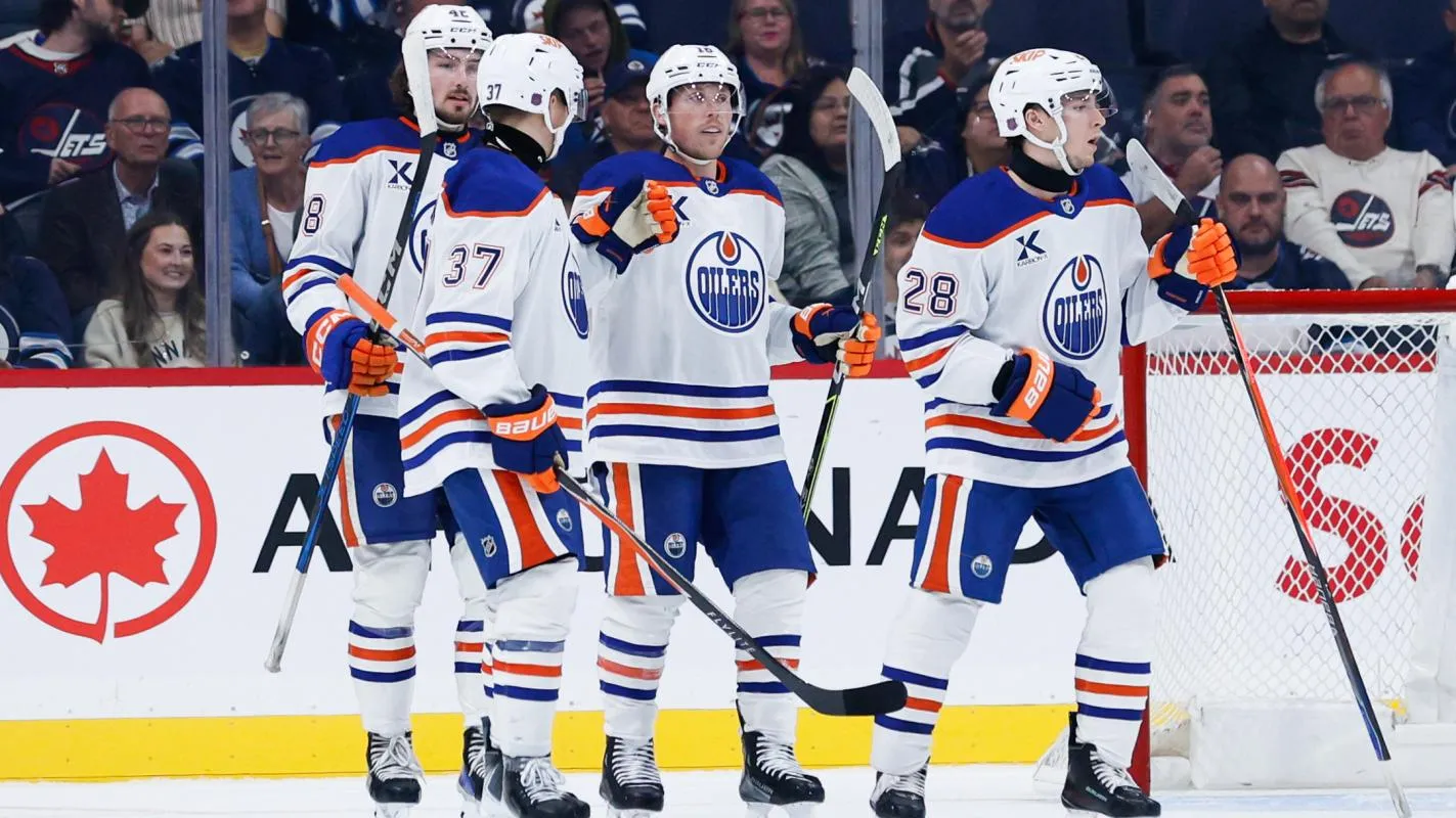 Edmonton Oilers forward Quinn Hutson (28) is congratulated by his teammates after scoring against the Winnipeg Jets during the second period at Canada Life Centre.