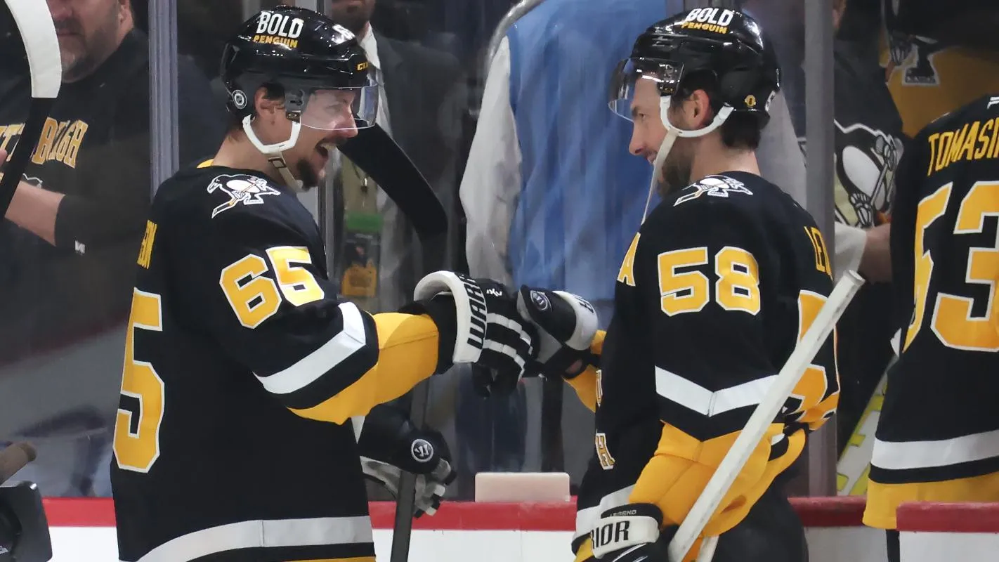 Pittsburgh Penguins defenseman Erik Karlsson (65) celebrates scoring the game winning goal in overtime with defenseman Kris Letang (58) after defeating the Vegas Golden Knights at PPG Paints Arena.