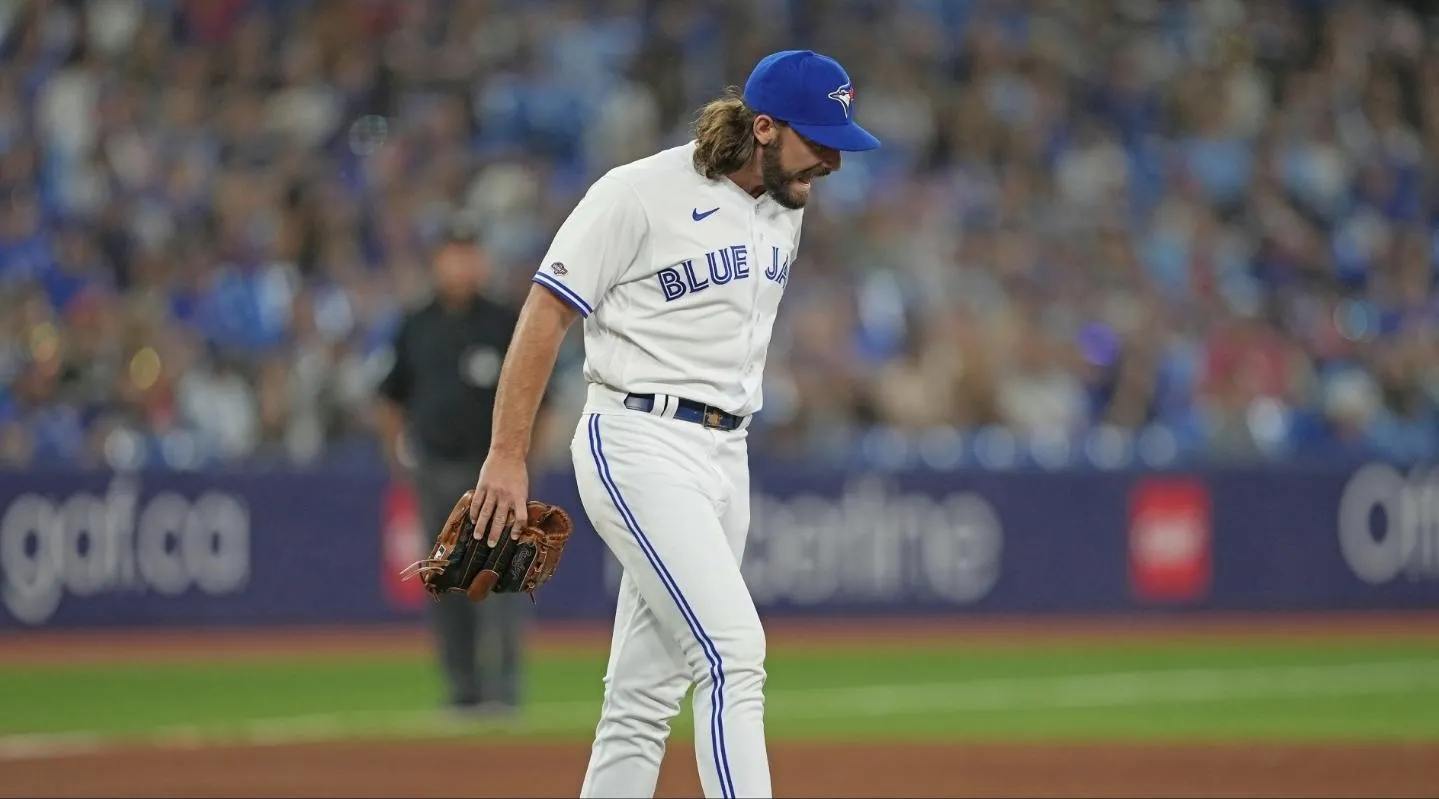 Toronto Blue Jays relief pitcher Hagen Danner (65) reacts in pain against the Chicago Cubs during the ninth inning at Rogers Centre.