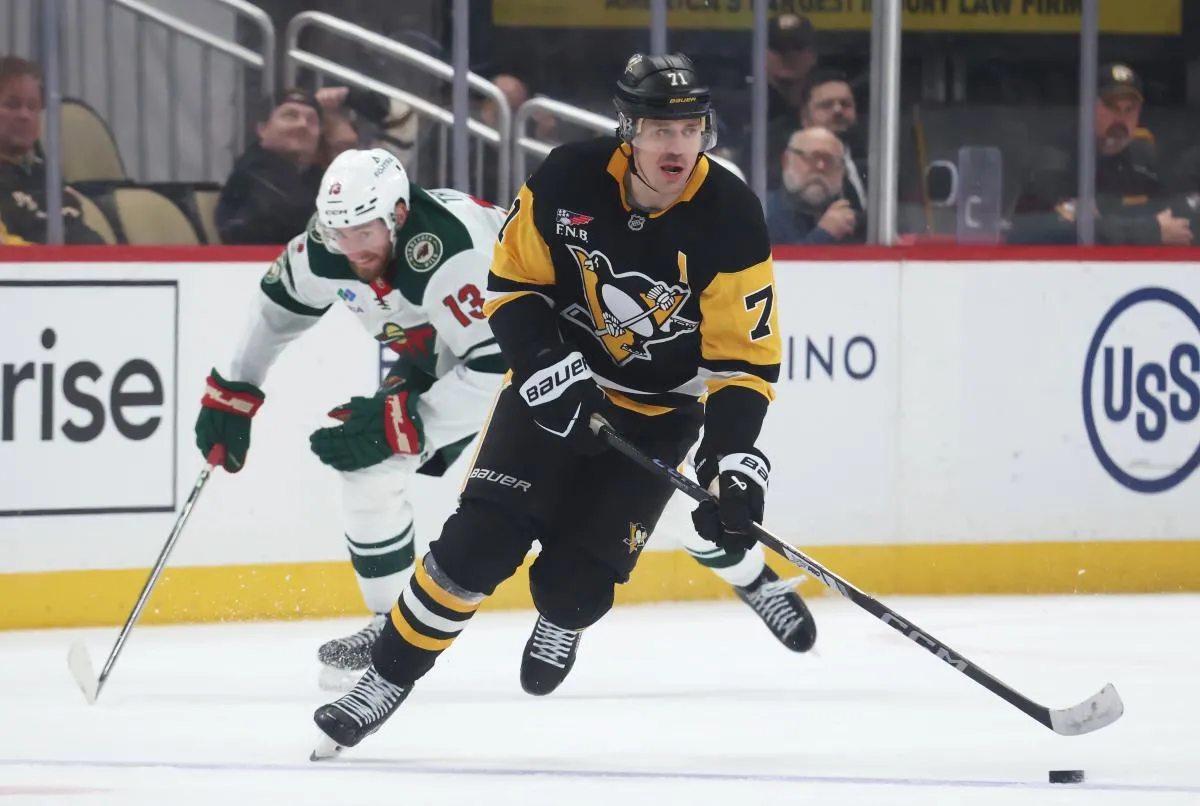 Pittsburgh Penguins center Evgeni Malkin (71) skates with the puck ahead of Minnesota Wild center Yakov Trenin (13) during the third period at PPG Paints Arena.