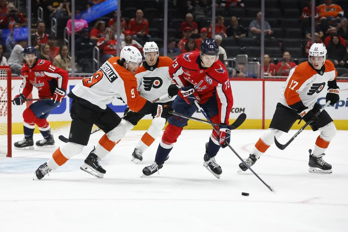 Washington Capitals forward Eriks Mateiko (73) and Philadelphia Flyers defenseman Jamie Drysdale (9) battle for the puck in the first period at Capital One Arena.