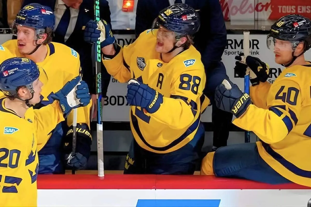 Toronto Maple Leafs forward William Nylander (center) and Vancouver Canucks forward Elias Pettersson (right) celebrate a goal scored by Team Sweden.