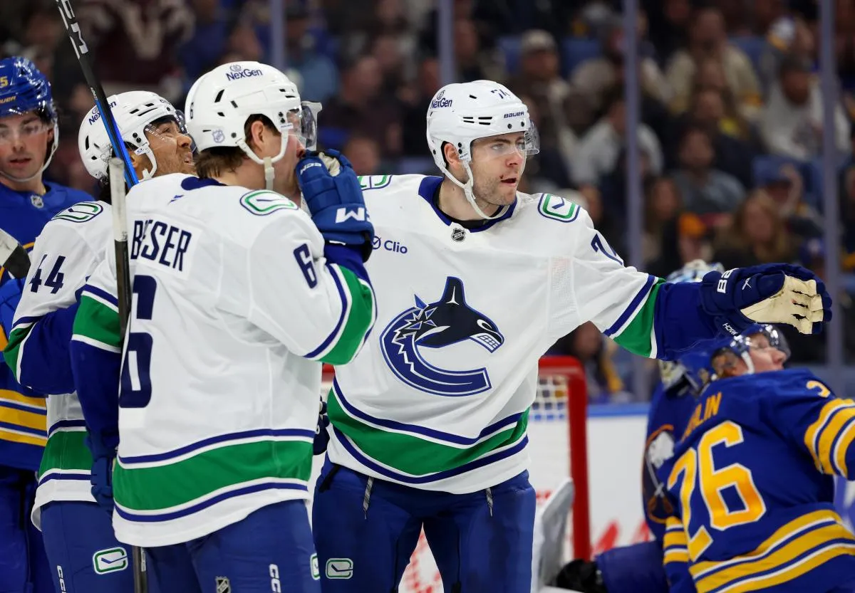 Vancouver Canucks left wing Jake Debrusk (74) celebrates his goal with teammates during the third period against the Buffalo Sabres at KeyBank Center.