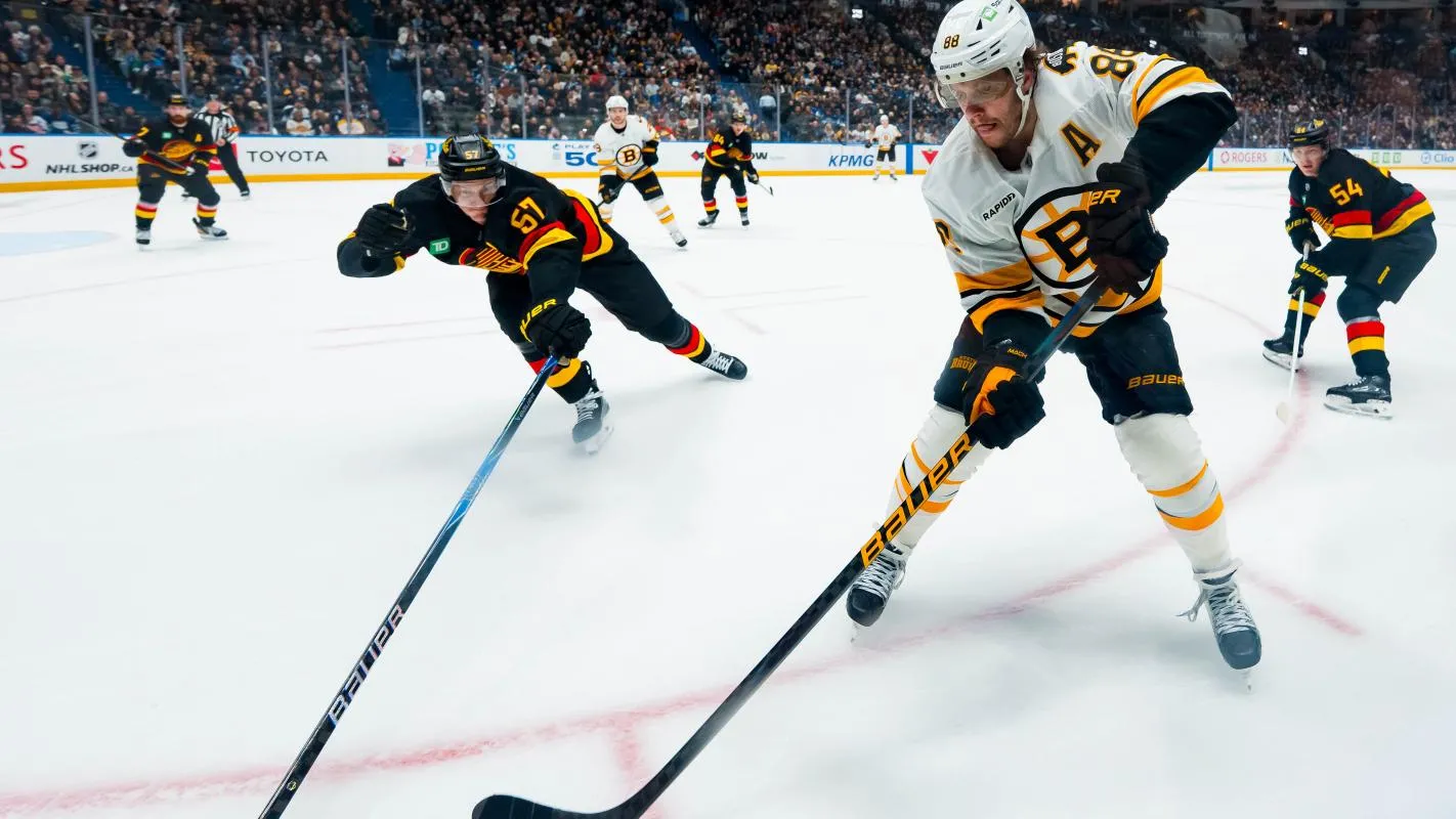 Vancouver Canucks defenseman Tyler Myers (57) defends against Boston Bruins forward David Pastrnak (88) in the second period at Rogers Arena.
