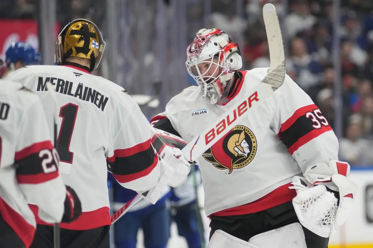Ottawa Senators goaltender Linus Ullmark (35) taps goaltender Leevi Merilainen (1) after getting pulled from the game during the second period at Scotiabank Arena.