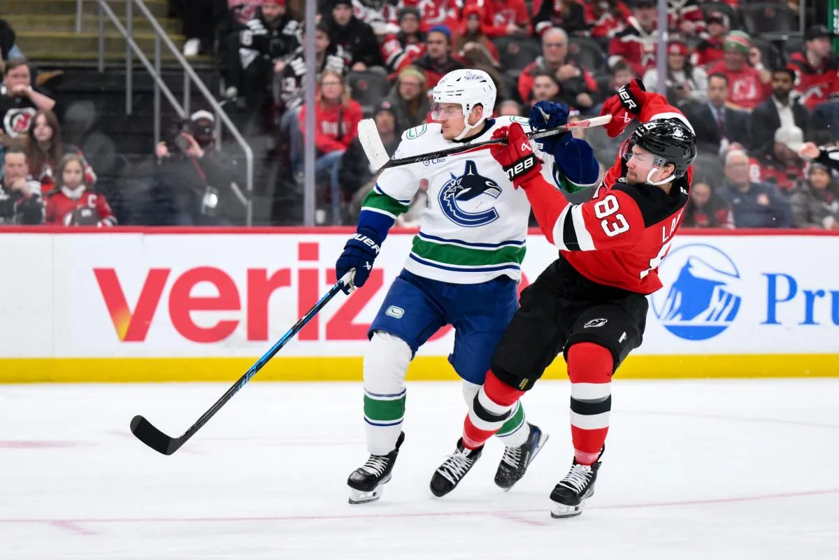 New Jersey Devils center Juho Lammikko (83) skates against Vancouver Canucks center David Kampf (64) during the second period at Prudential Center.