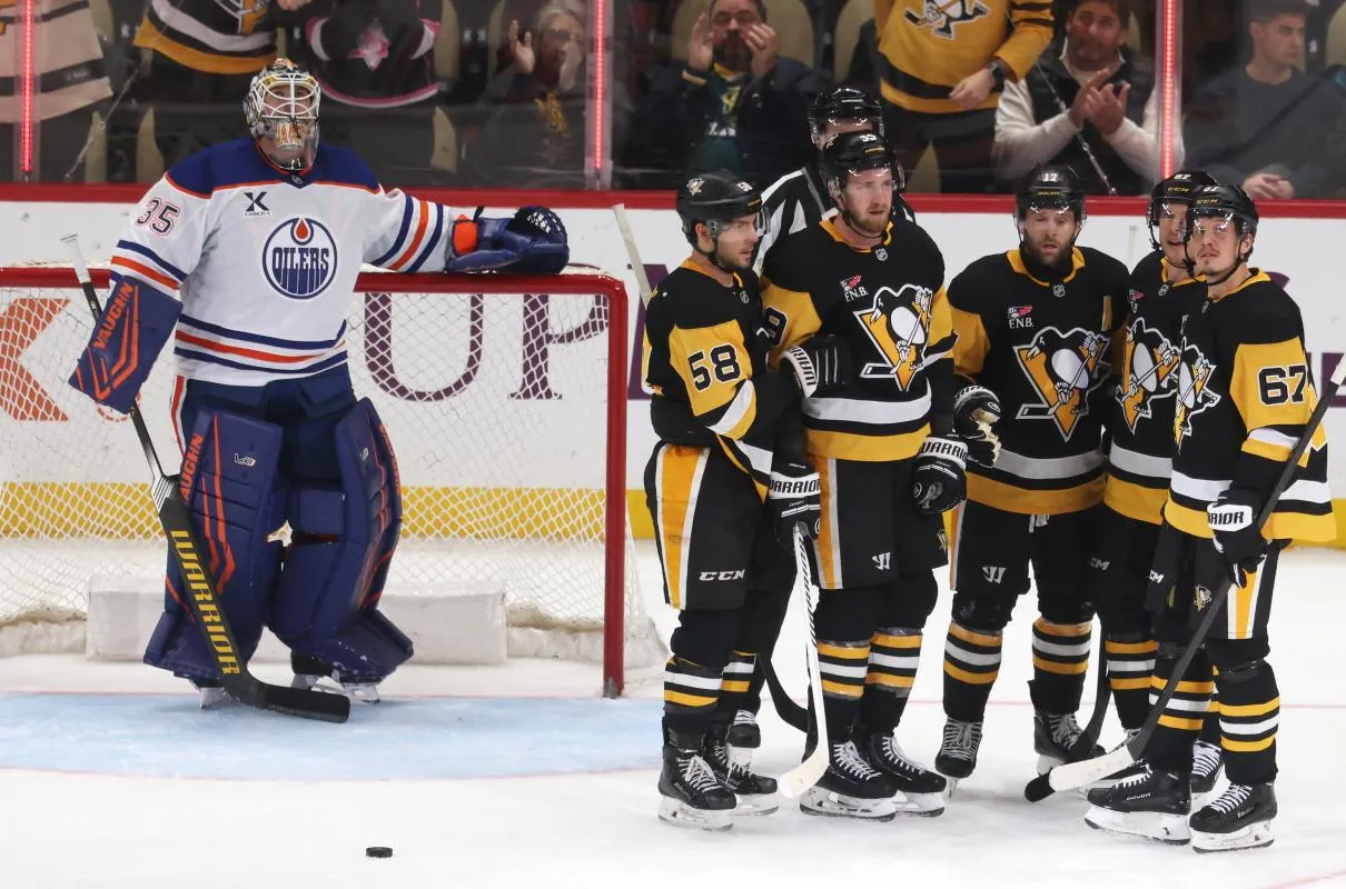 The Pittsburgh Penguins celebrate a goal by right wing Bryan Rust (middle) against Edmonton Oilers goaltender Tristan Jarry (35) during the third period at PPG Paints Arena.