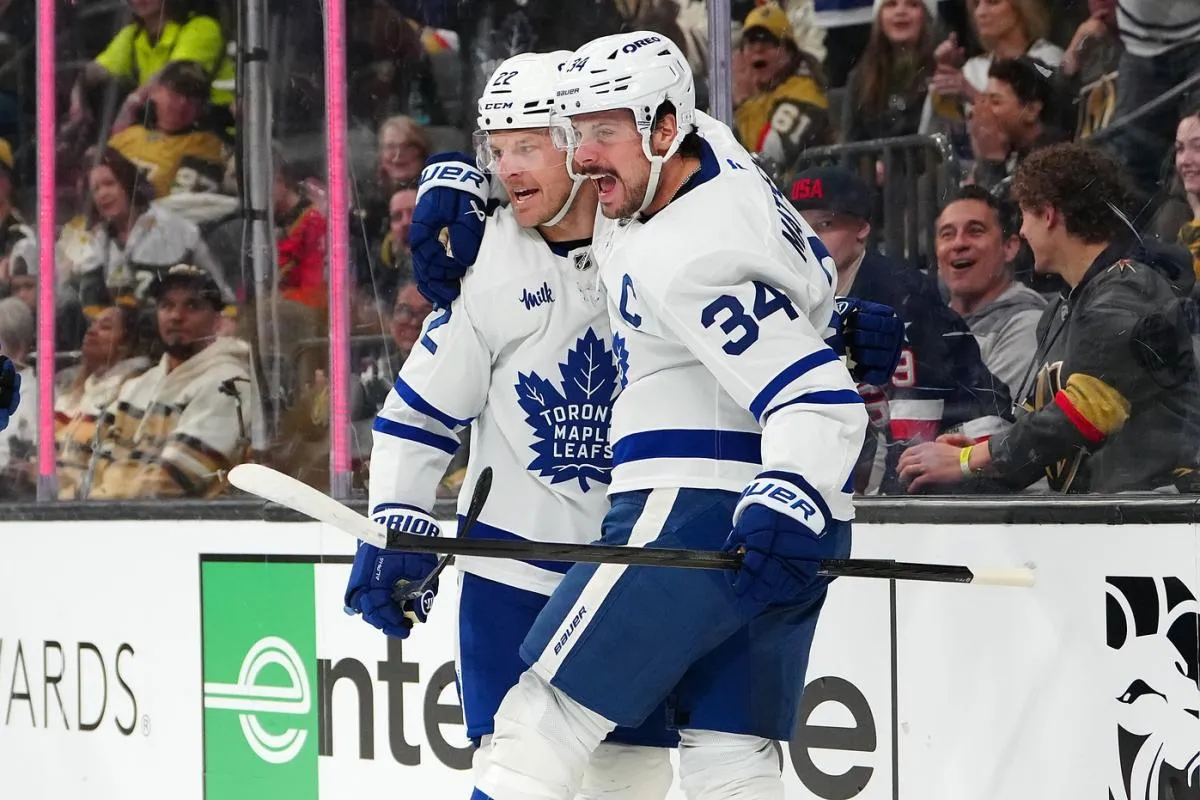 Toronto Maple Leafs center Auston Matthews (34) celebrates with Toronto Maple Leafs defenseman Jake McCabe (22) after scoring a goal against the Vegas Golden Knights during the first period at T-Mobile Arena.