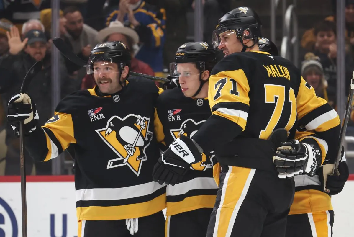 Pittsburgh Penguins right wing Bryan Rust (17) and center Evgeni Malkin (71) congratulate center Ben Kindel (middle) on his goal against the Toronto Maple Leafs during the first period at PPG Paints Arena.