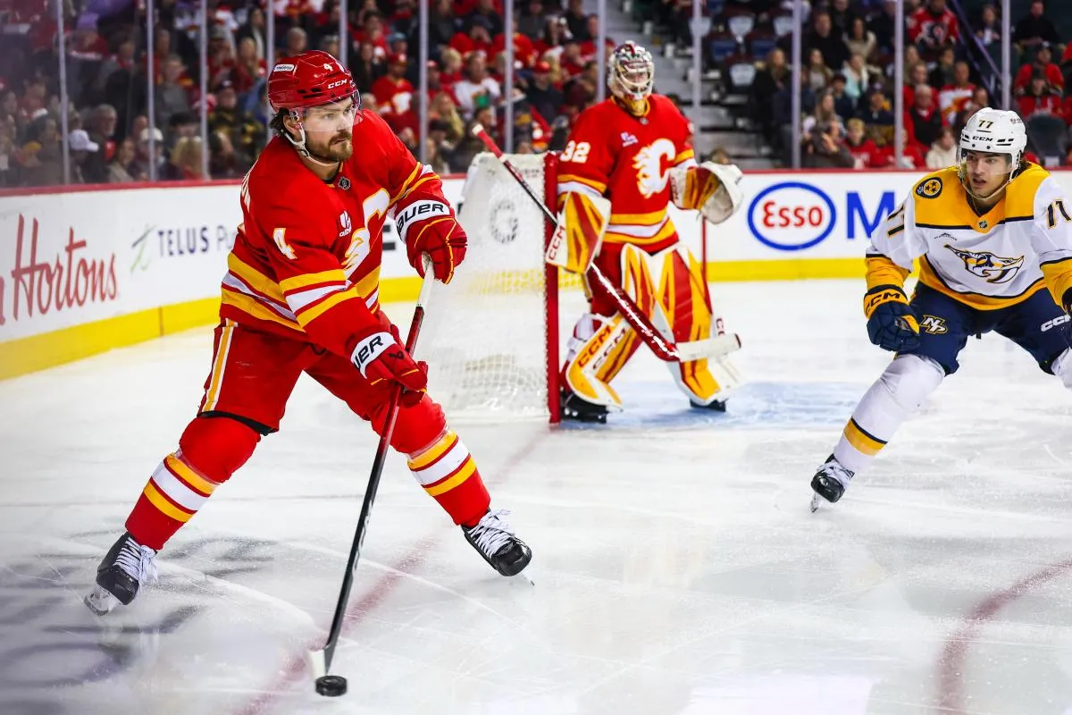 Calgary Flames defenseman Rasmus Andersson (4) controls the puck against the Nashville Predators during the third period at Scotiabank Saddledome.