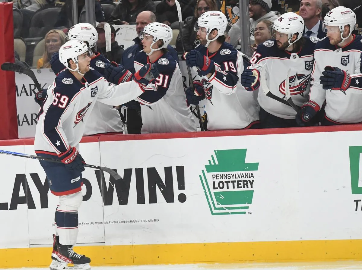 Columbus Blue Jackets right wing Yegor Chinakhov (59) is greeted by the bench after scoring against the Pittsburgh Penguins during the third action at PPG Paints Arena.