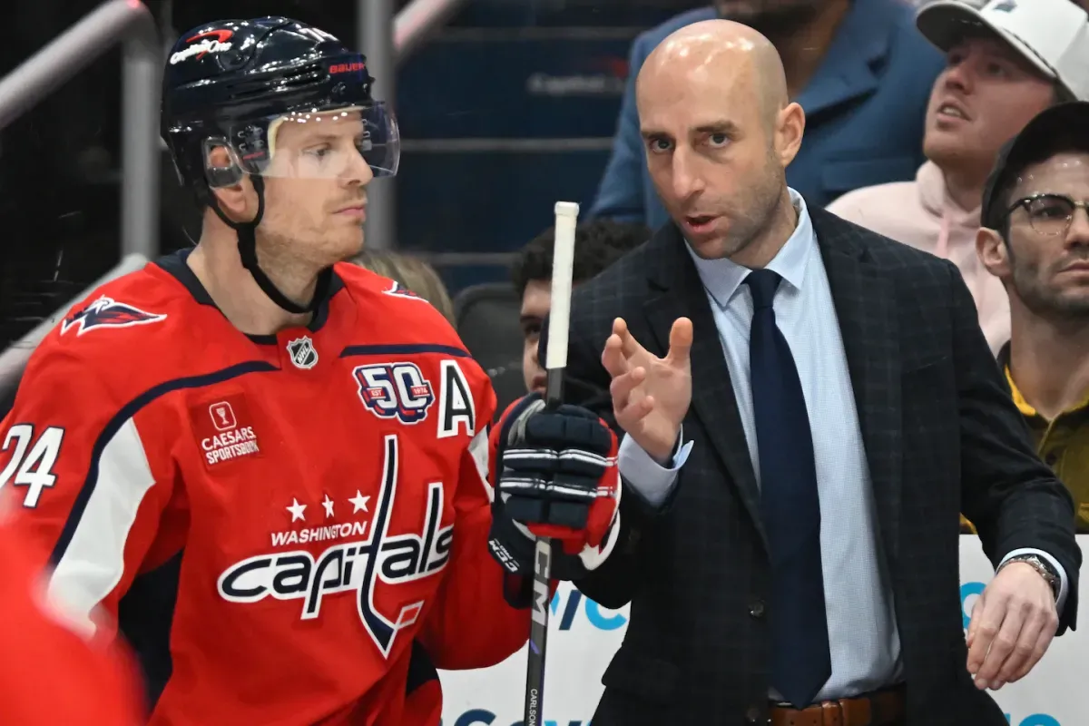 Washington Capitals assistant coach Mitch Love speaking to defenseman John Carlson.