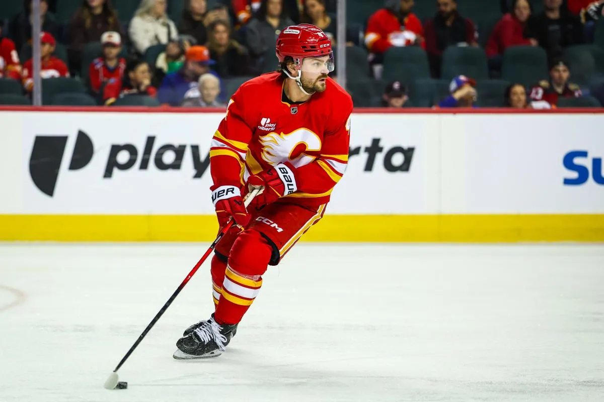 Calgary Flames defenseman Rasmus Andersson (4) skates with the puck against the New York Islanders during the third period at Scotiabank Saddledome.