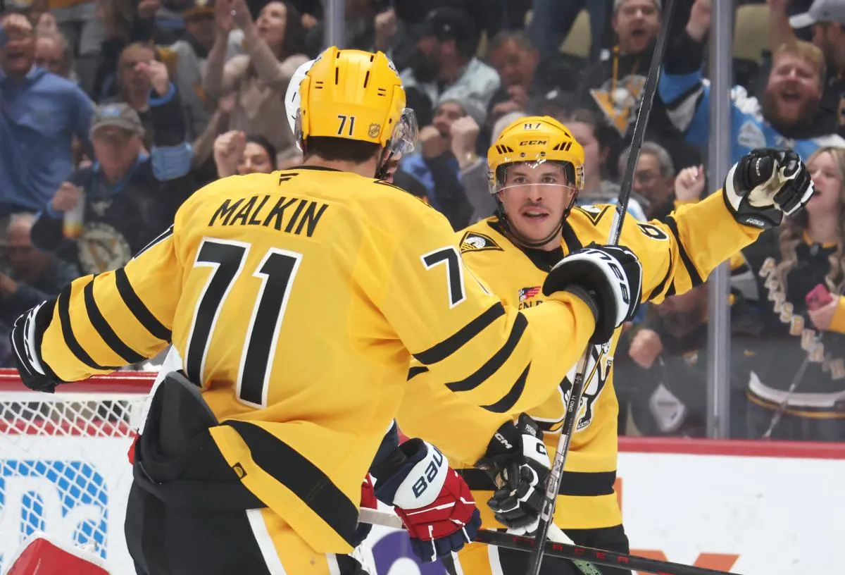 Pittsburgh Penguins center Sidney Crosby (87) celebrates his second power play goal of the game with center Evgeni Malkin (71) against the Washington Capitals during the first period at PPG Paints Arena.