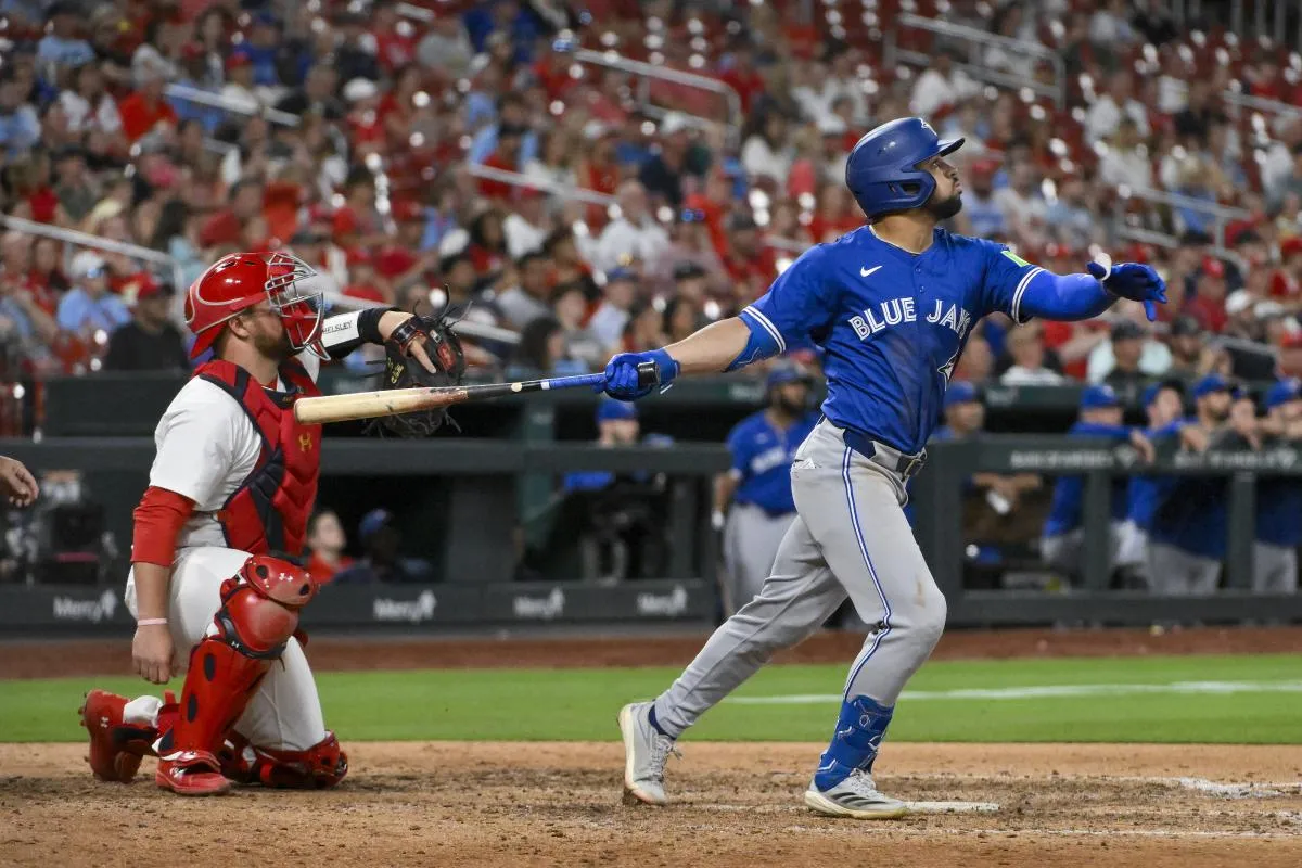Toronto Blue Jays center fielder Jonatan Clase (8) hits a game tying solo home run off of St. Louis Cardinals relief pitcher Ryan Helsley (not pictured) during the ninth inning at Busch Stadium.