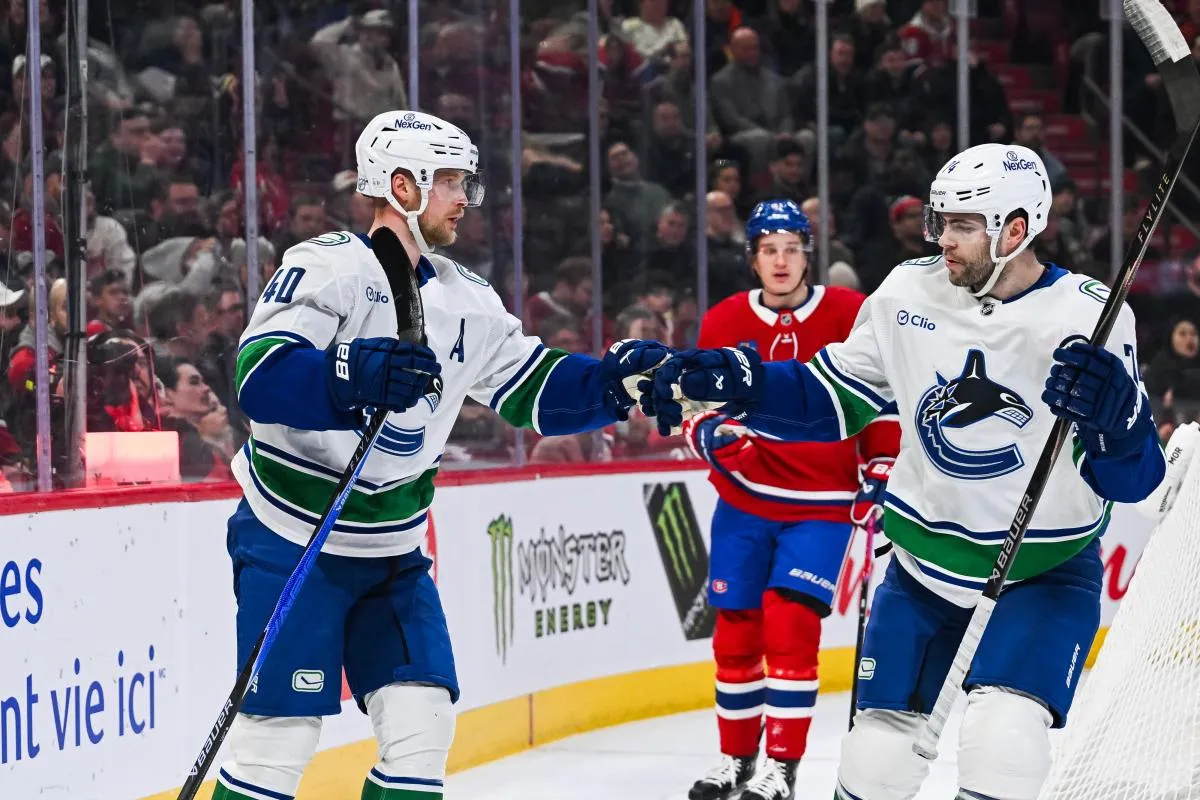 Vancouver Canucks center Elias Pettersson (40) celebrates with left wing Jake DeBrusk (74) his goal against the Montreal Canadiens during the first period at Bell Centre.